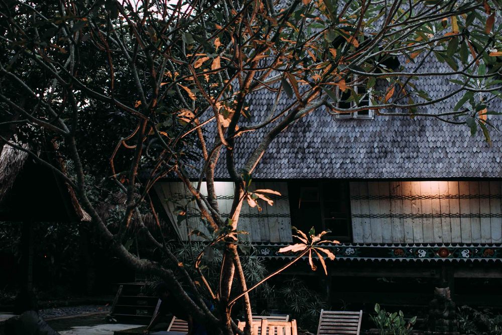 A backyard pool and lounge chairs at dusk